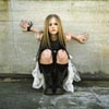 Avril Sitting Against a Wall